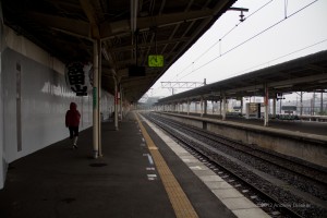 Narita station platform, with one lone person, in the rain