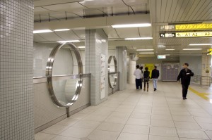 circular cutouts in the walls protecting the escalator