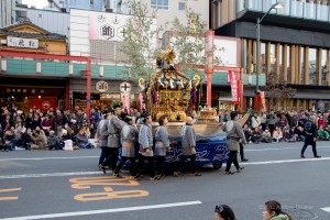 men pushing a portable shrine
